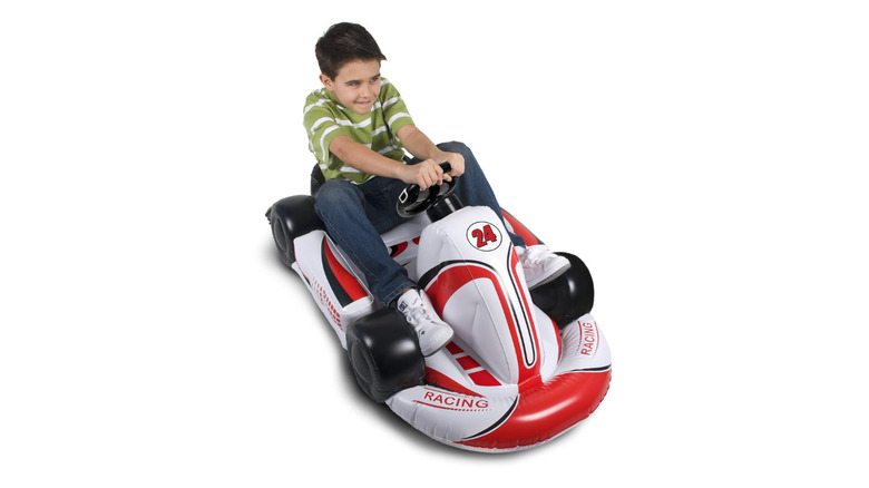 Child in inflatable racing kart with intergrated Wii Remote