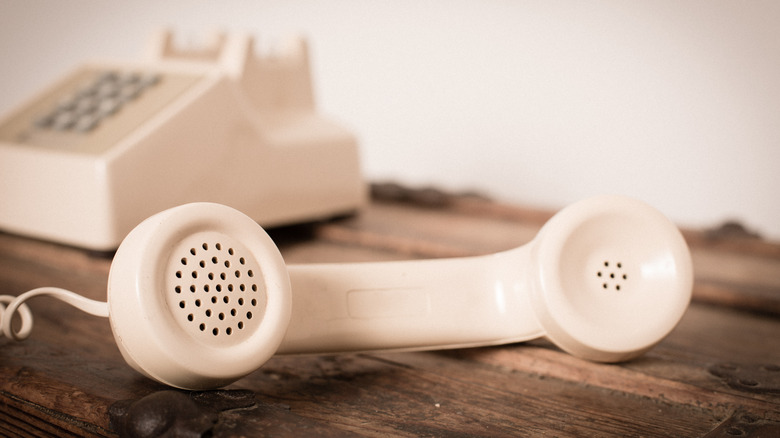 A basic old landline phone off the receiver.