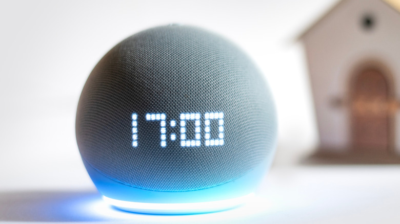 Amazon Echo smart speaker showing 17:00 on its LED clock display.