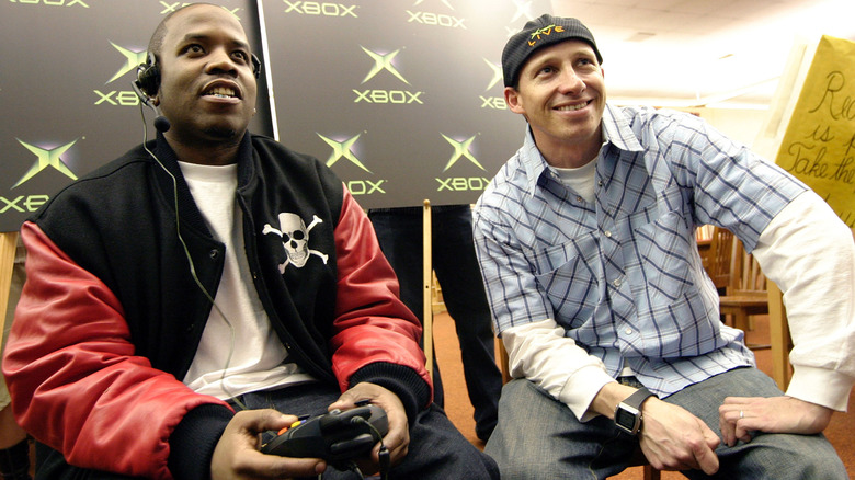 Two people in an Xbox event with one of them with a console in hand