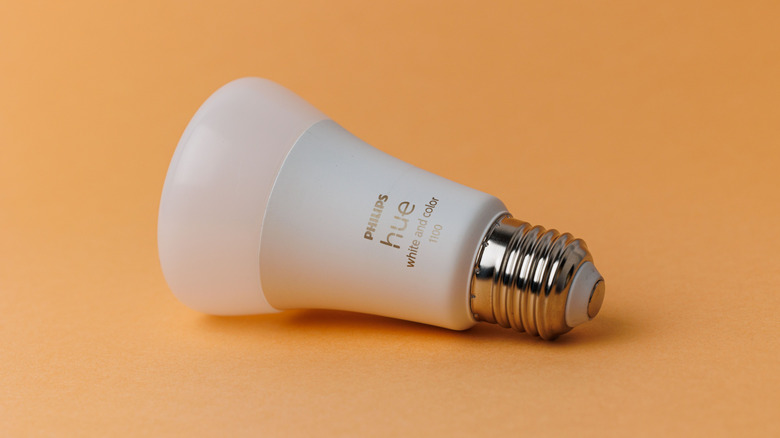 A Philips Hue bulb on an orange background