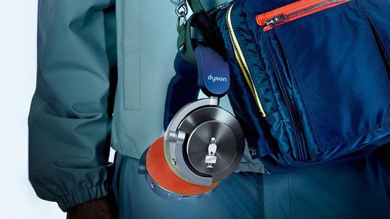 Dyson OnTrac headphones hanging from a bag strap.
