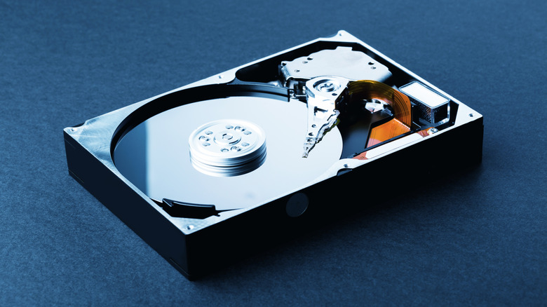 An old mechanical hard drive with exposed platter