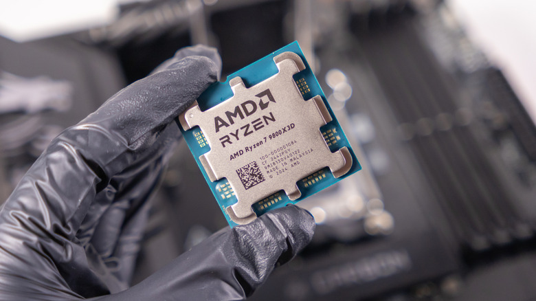 Hand holding AMD Ryzen 7 9800X3D