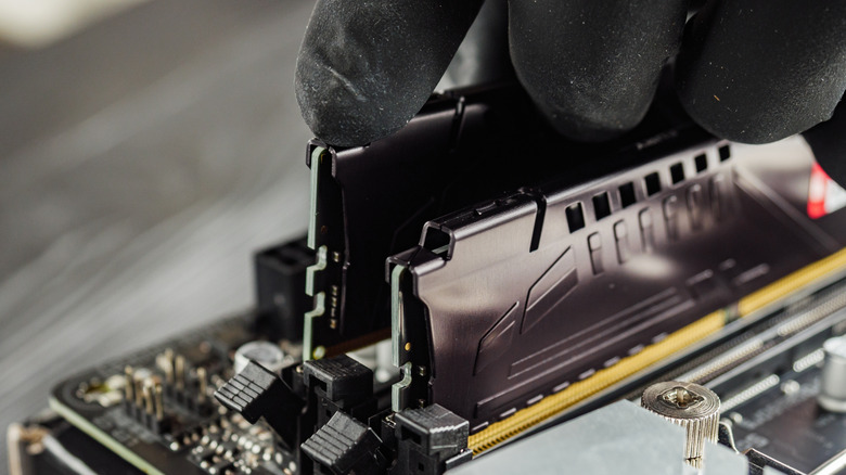 Two sticks of RAM being installed