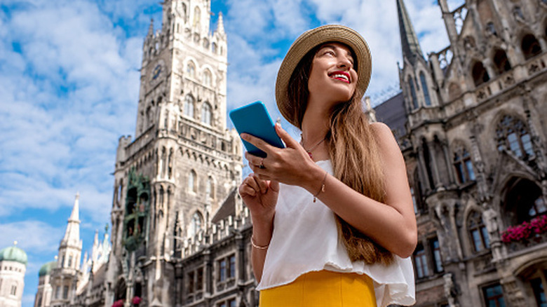 A woman using her phone while on a trip abroad.