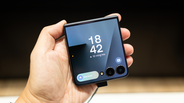 A Samsung Galaxy Z Flip showing the time on its cover display