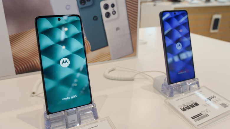 Motorola phones displayed on stands in an electronics store.