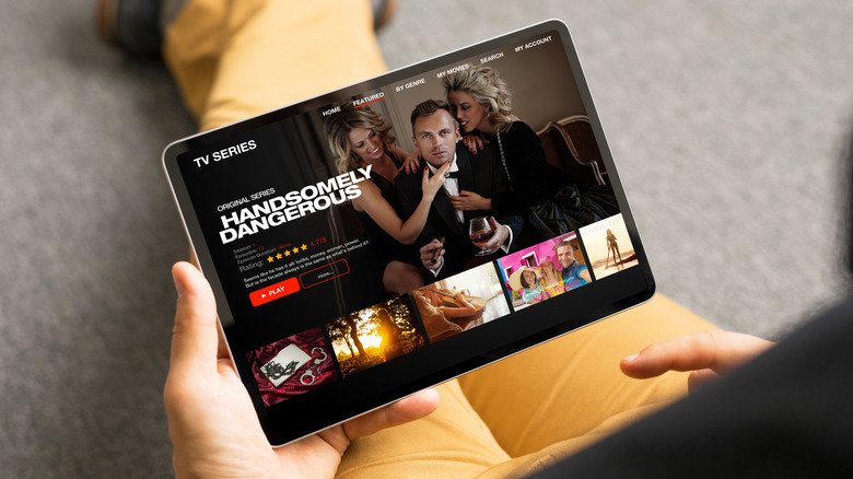 Person watching a TV show on a tablet screen