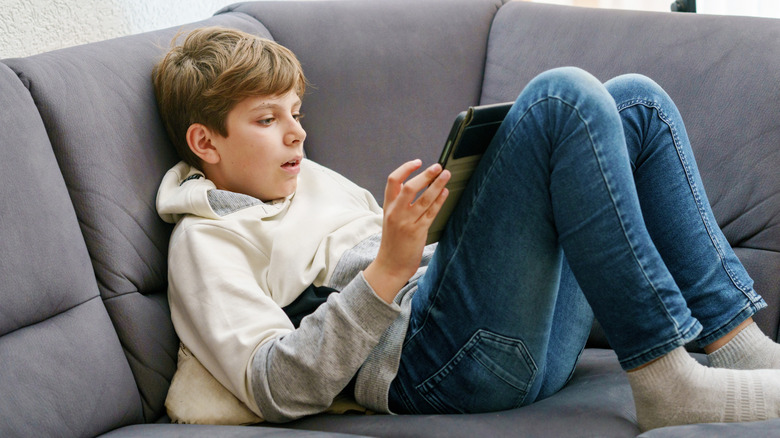 Teenager using a tablet for gaming