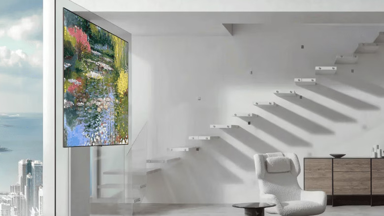 LG's thin W6 OLED TV mounted on a glass panel in a modern home
