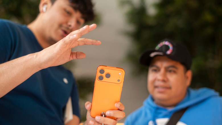 apple staff assisting a customer with iPhone 17 Pro purchase
