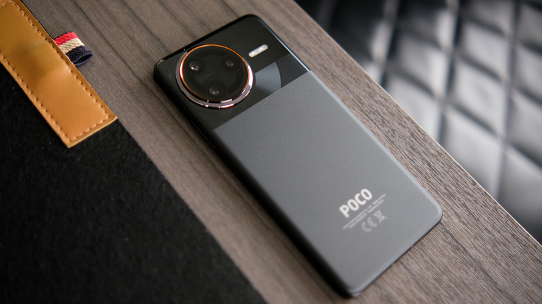 Poco F7 Ultra smartphone placed on a wooden surface