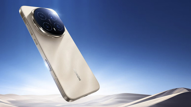 A golden Honor Magic8 Pro floating in front a digitally rendered desert scene with a blue sky.