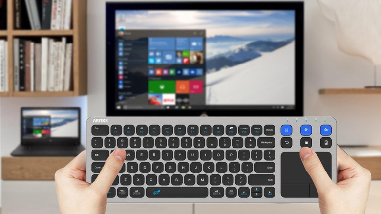 A person using the Arteck HD197 keyboard with a smart TV