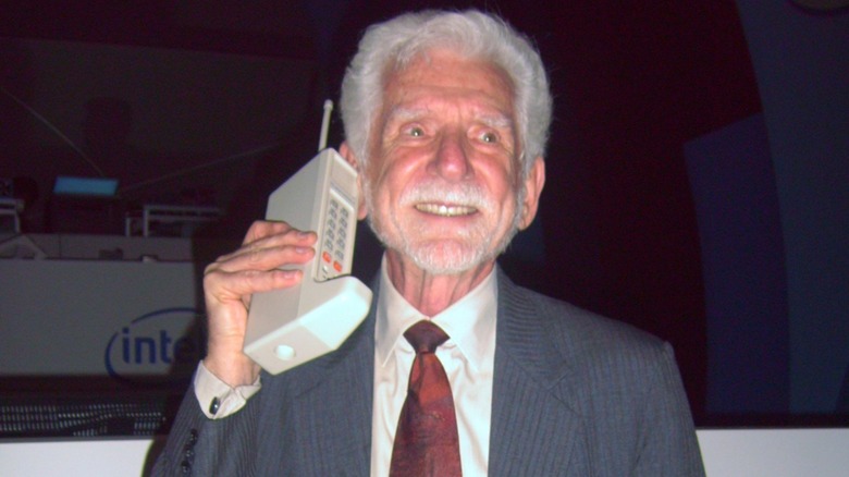 Electrical engineer Martin Cooper holding a DynaTAC Cellular Phone prototype