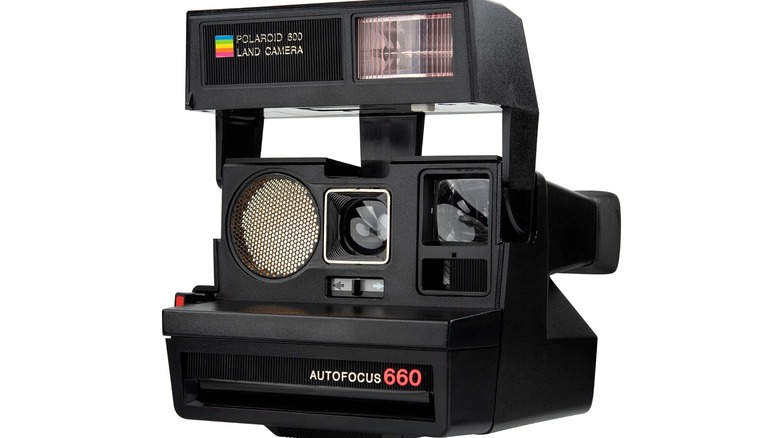 Polaroid Sun 660 Instant Film Camera in front of a white background
