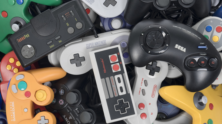 A pile of various video game console controllers