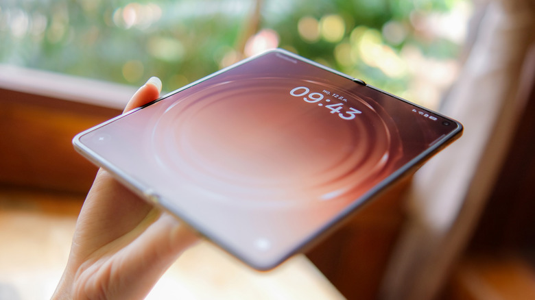 The Oppo Find N6 foldable phone in hand.