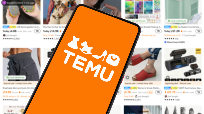 A phone with the Temu logo on it in front of a screen displaying various items on Temu