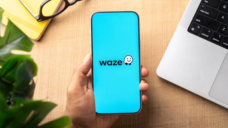 Waze logo displayed on the screen of a smartphone