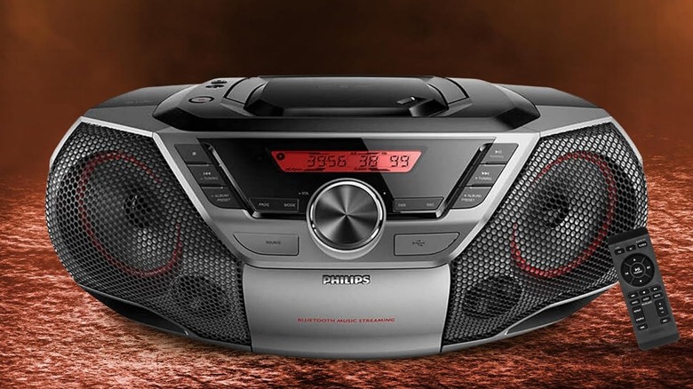 A black Philips Portable Boombox with a red LED display, the image also shows the remote that comes with the device