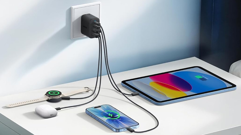 The Anker Zolo charger plugged into an outlet with four devices connected.