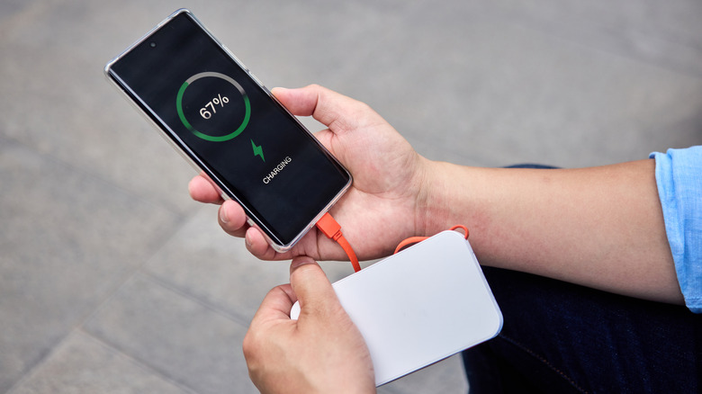 A power bank charging a phone