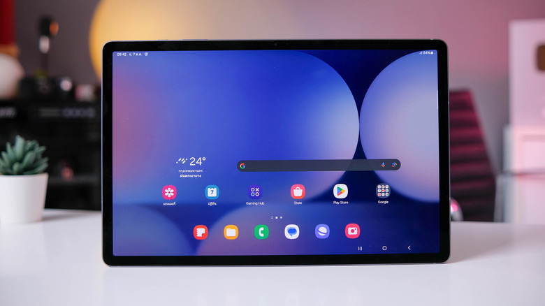 Samsung Galaxy Tab S10+ displaying its home screen on a desk.