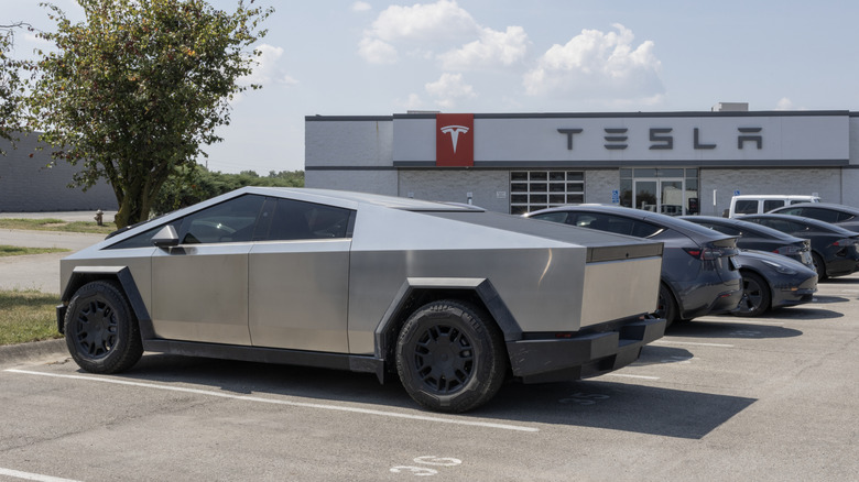 Tesla Cybertruck parked outside a Tesla showroom.