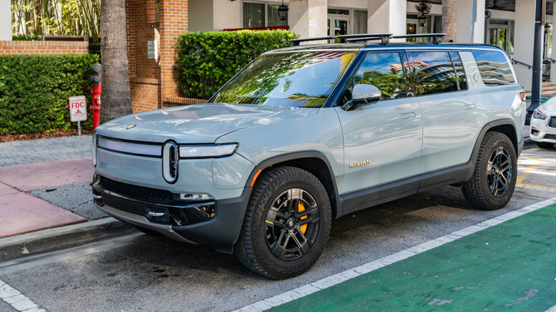 Rivian R1S Quad electric SUV parked on a city street.