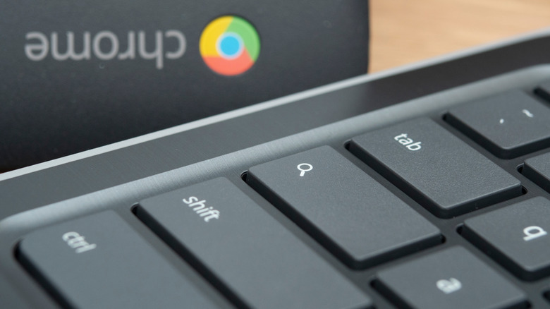 Chromebook keyboard close up with the Chrome logo on a box in the background