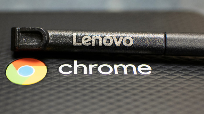 Close-up of a Chromebook with the Chrome and Lenovo logo and stylus visible.