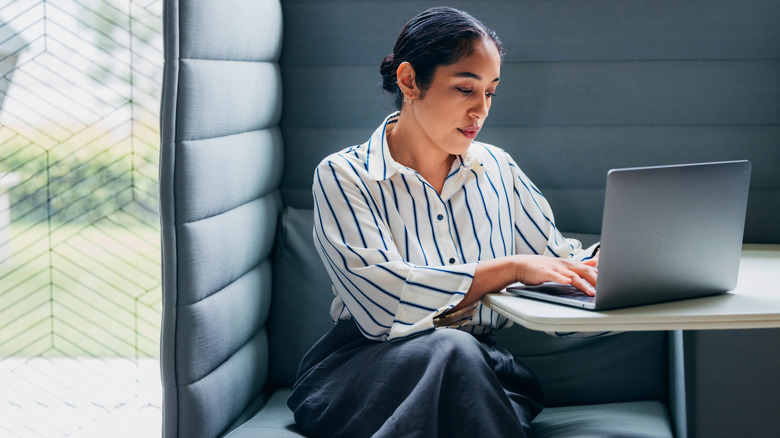 A woman working productively in an office pod