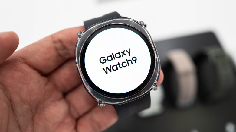 Buyer holding a Galaxy Watch9 in the Samsung Store