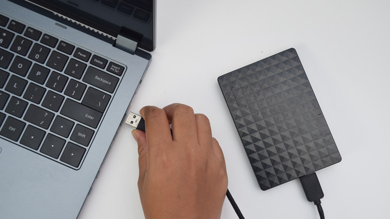 Connecting an external drive to a laptop.