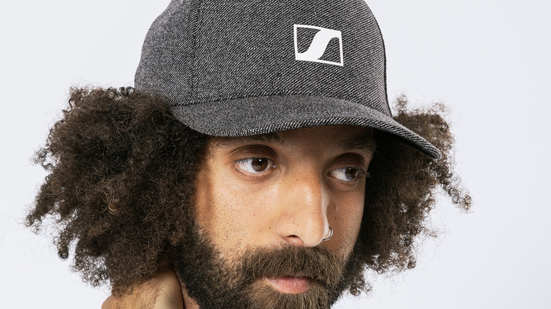 A man wearing a Sennheiser-branded cap.