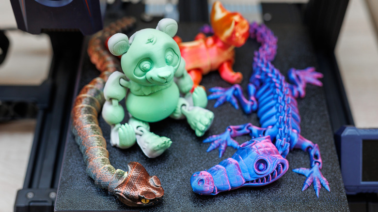 Multiple 3D printed project adhered to a print bed on a 3D printer