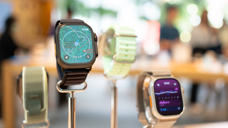 Multiple Apple Watches on display in a store.