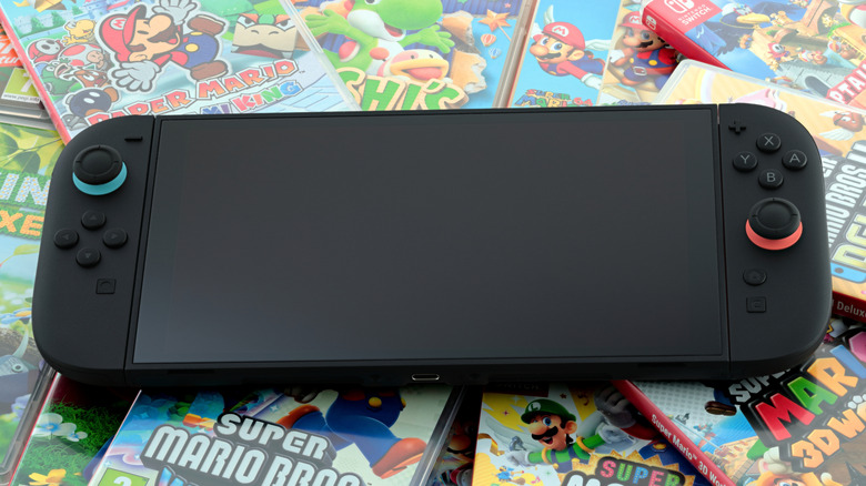 Nintendo Switch 2 sitting on a pile of game cases