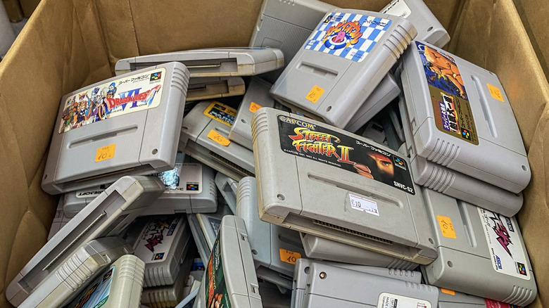 Old video game cartridges inside of a cardboard box