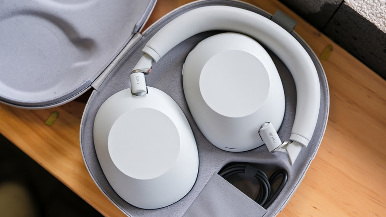 A set of wireless headphones in their carrying case