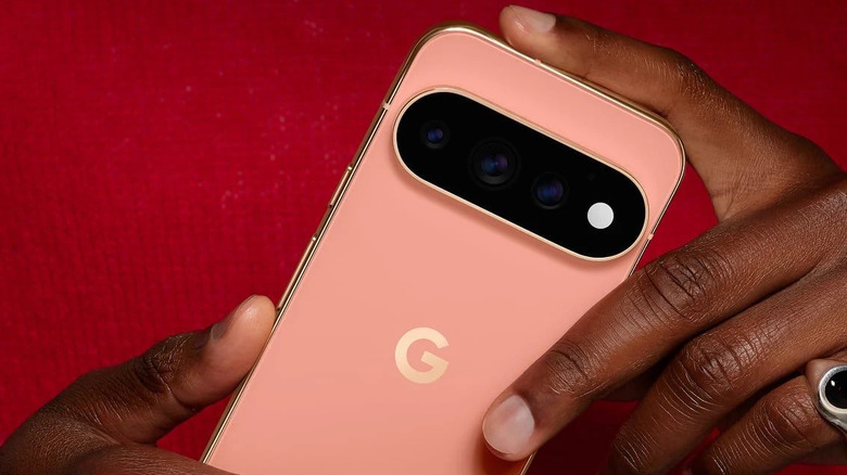 Pixel 11 Pro held in hands showing rear of phone with logo and camera bump