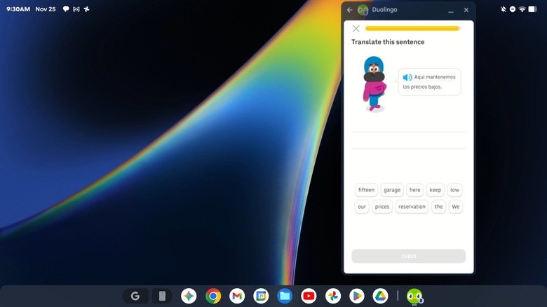 An example of someone using the Android phone mirroring option on a Googlebook, the image shows a Googlebook desktop with an Android emulator running the Duolingo app