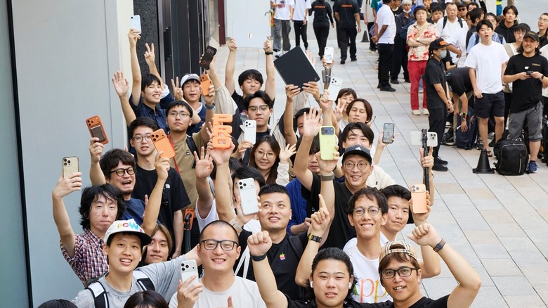 Apple customers queuing outside an Apple Store