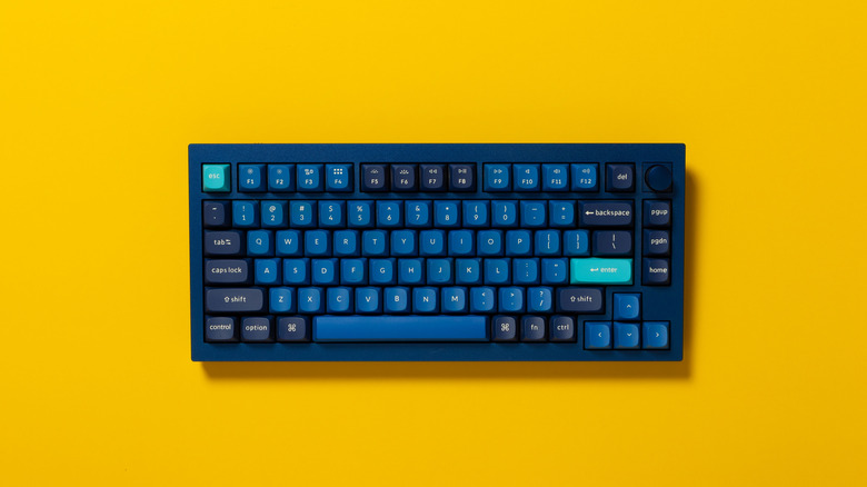 A blue mechanical keyboard against a yellow background