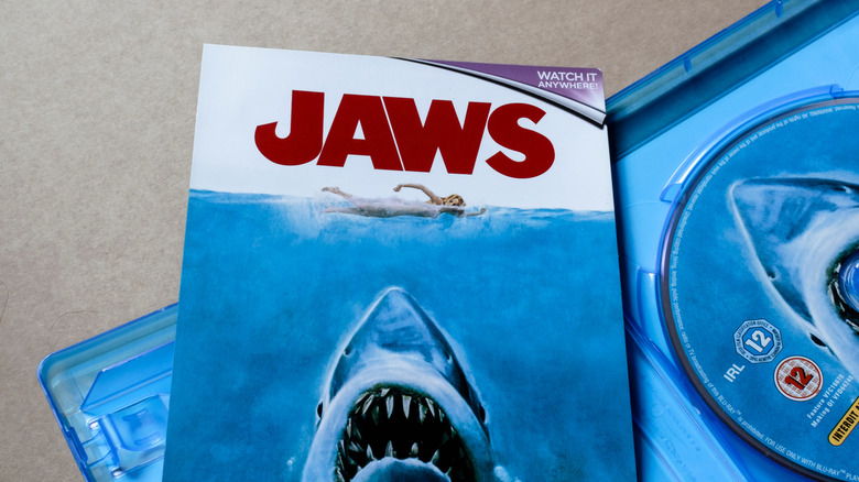 Jaws Blu-ray case open with disc and cover art showing the shark attack poster.