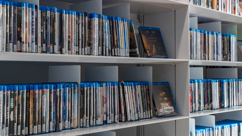Shelves filled with Blu-ray movie cases organized in a home collection.