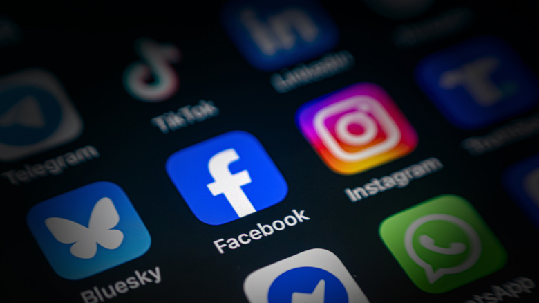 Facebook App icon among various application icons on smartphone screen