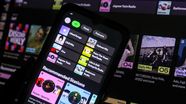 a desktop and a smartphone screen showing Spotify's playlists